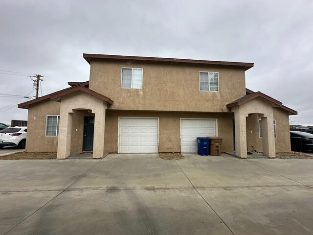 20204 Mini Ct, Tehachapi, CA 93561 - view of front facade featuring concrete driveway, stucco siding, and a garage