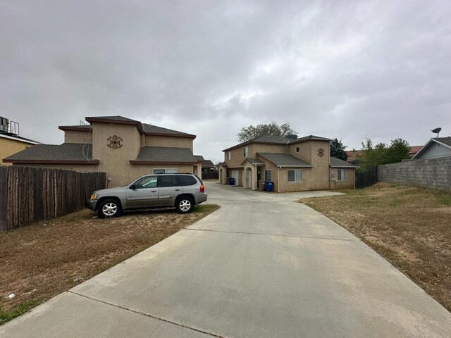 20204 Mini Ct, Tehachapi, CA 93561 - exterior space featuring concrete driveway, stucco siding, a garage, and fence