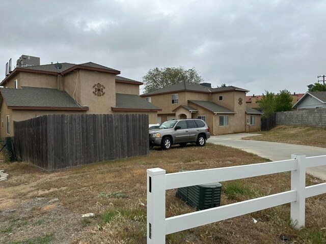 20204 Mini Ct, Tehachapi, CA 93561 - exterior space featuring stucco siding, driveway, and fence private yard