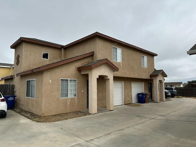 20204 Mini Ct, Tehachapi, CA 93561 - view of front of house featuring driveway, stucco siding, and a garage