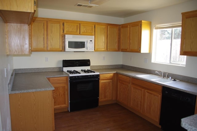 kitchen featuring a sink, dishwasher, range with gas stovetop, white microwave, and visible vents