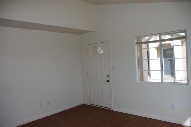 entryway with baseboards and dark wood-type flooring