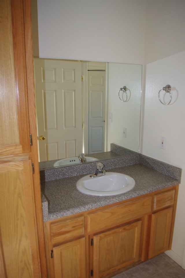bathroom featuring tile patterned flooring and vanity