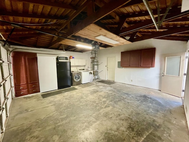 garage featuring freestanding refrigerator and separate washer and dryer