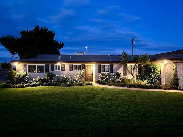 single story home featuring a front lawn