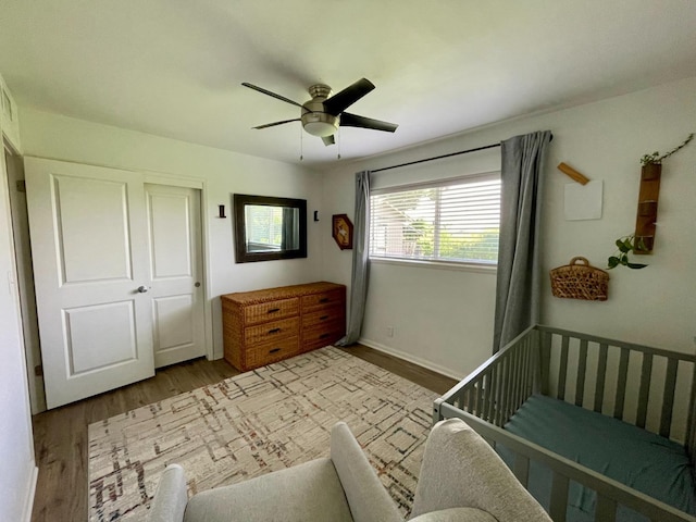 bedroom with baseboards, ceiling fan, and wood finished floors