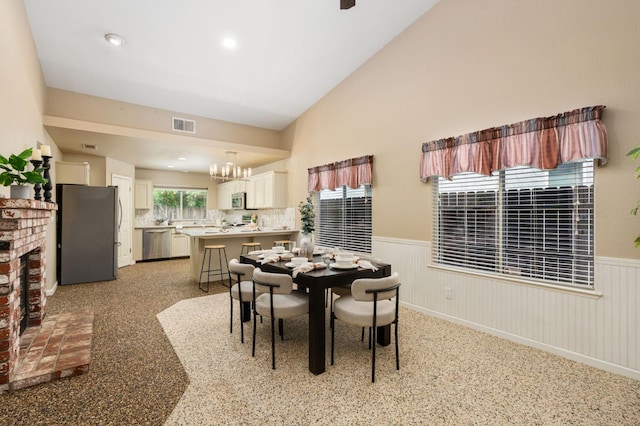 4650 W Chennault Ave, Fresno, CA 93722 - dining area with a wainscoted wall and a chandelier