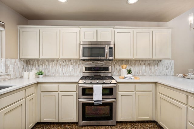 4650 W Chennault Ave, Fresno, CA 93722 - kitchen with stainless steel appliances, decorative backsplash, light countertops, and recessed lighting