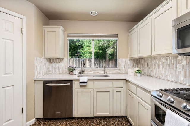 4650 W Chennault Ave, Fresno, CA 93722 - kitchen with stainless steel appliances, a sink, tasteful backsplash, light countertops, and white cabinetry