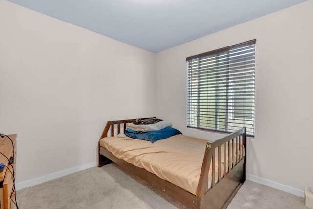 bedroom with carpet floors and baseboards