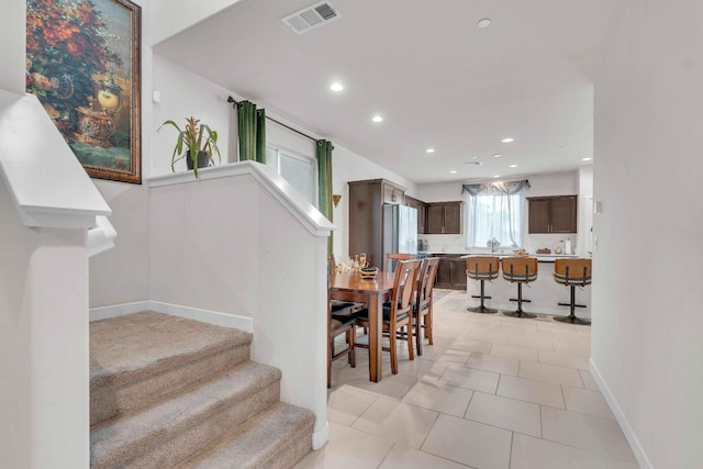 stairs featuring visible vents, recessed lighting, baseboards, and tile patterned flooring