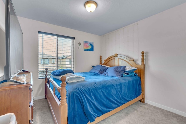 bedroom with carpet floors and baseboards