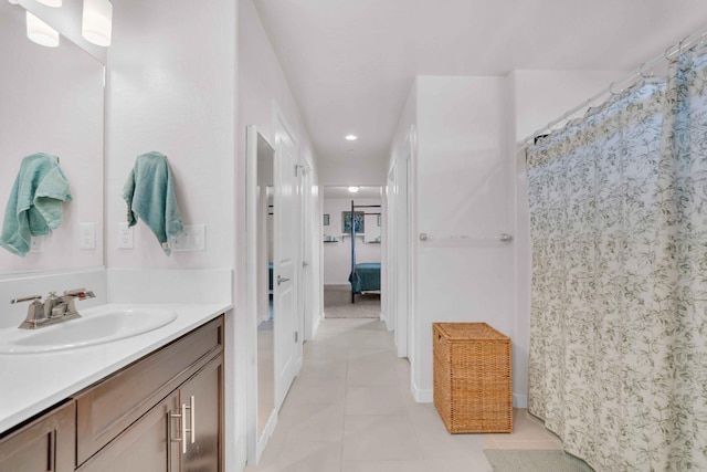 bathroom featuring tile patterned flooring, vanity, baseboards, recessed lighting, and a shower with curtain