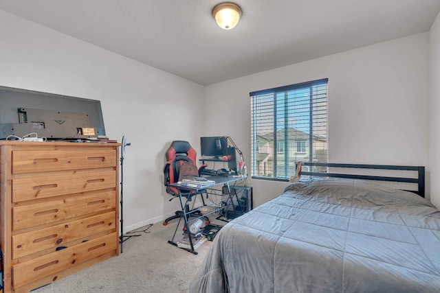 bedroom with carpet floors and baseboards