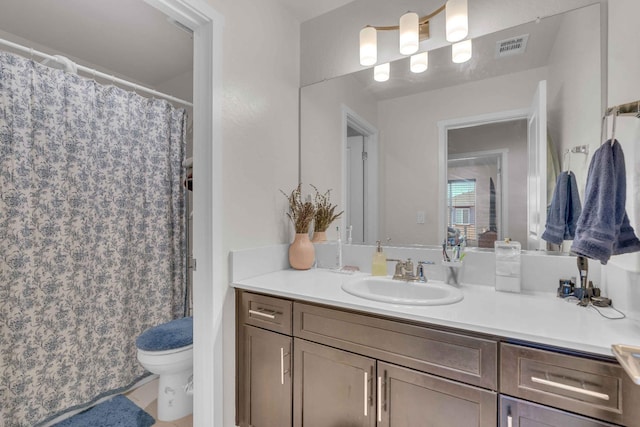 bathroom with visible vents, toilet, and vanity