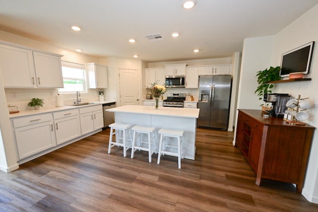 1845 George Ave, Sanger, CA 93657 - kitchen with stainless steel appliances, a sink, white cabinets, a center island, and a breakfast bar area