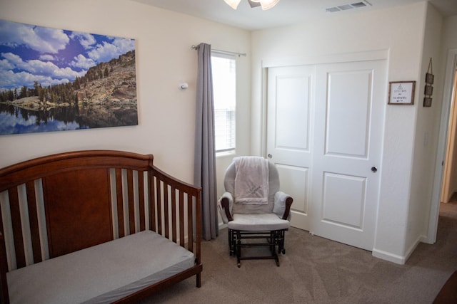 bedroom featuring carpet floors, baseboards, visible vents, and a closet
