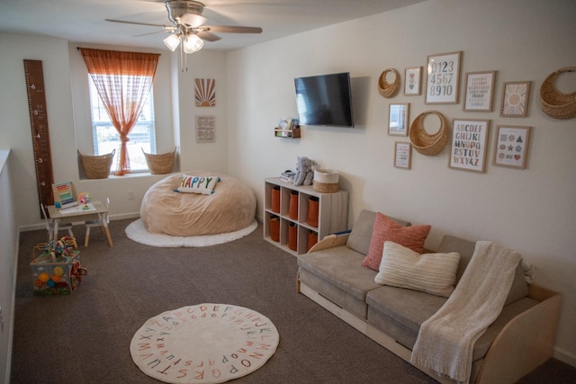carpeted living area with a ceiling fan