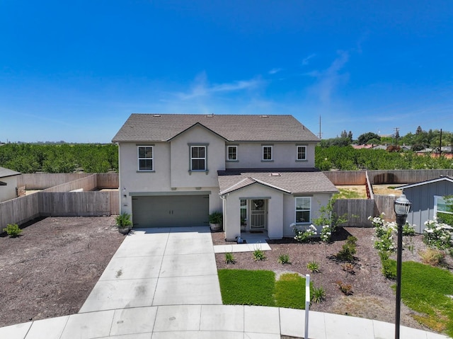 1845 George Ave, Sanger, CA 93657 - traditional-style house with stucco siding, a garage, driveway, fence, and a shingled roof