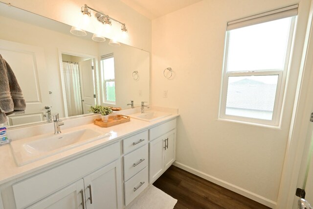 1845 George Ave, Sanger, CA 93657 - full bath with wood finished floors, plenty of natural light, baseboards, and double vanity