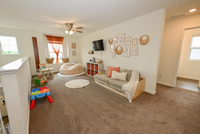 1845 George Ave, Sanger, CA 93657 - carpeted living area with plenty of natural light, a ceiling fan, and baseboards