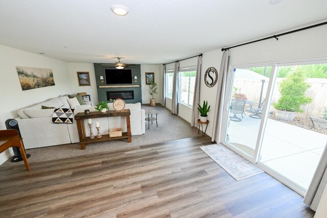 1845 George Ave, Sanger, CA 93657 - living area featuring ceiling fan, healthy amount of natural light, a fireplace, and wood finished floors
