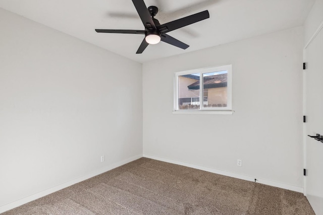 carpeted empty room featuring baseboards and a ceiling fan