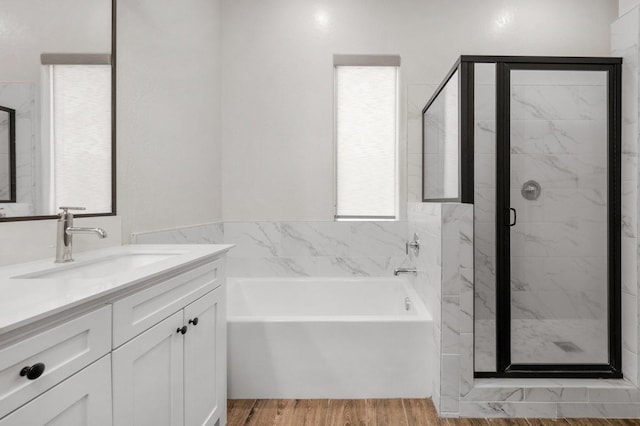 855 Groveland Ave W, Madera, CA 93636 - bathroom featuring vanity, a shower stall, a garden tub, and wood finished floors
