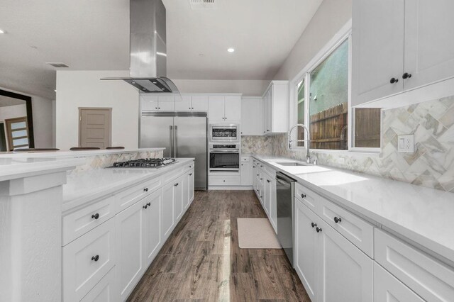 855 Groveland Ave W, Madera, CA 93636 - kitchen with island exhaust hood, a sink, white cabinetry, and built in appliances