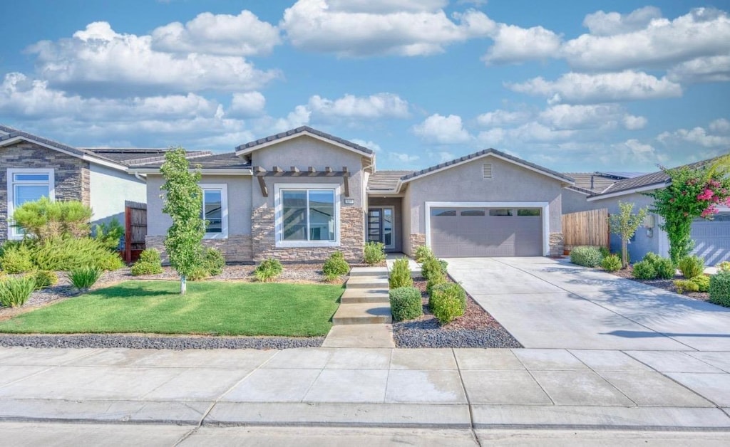 ranch-style house with a garage, a front lawn, stucco siding, and stone siding
