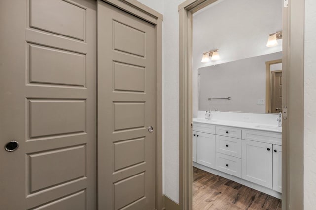 855 Groveland Ave W, Madera, CA 93636 - bathroom featuring double vanity, a sink, and wood finished floors
