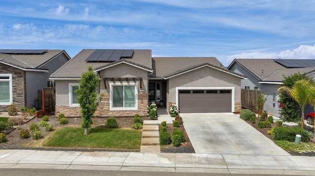 855 Groveland Ave W, Madera, CA 93636 - view of front of property with a garage, fence, stone siding, stucco siding, and solar panels