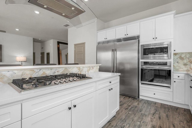 855 Groveland Ave W, Madera, CA 93636 - kitchen with built in appliances, white cabinetry, decorative backsplash, and light countertops