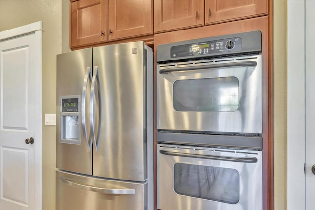 kitchen with brown cabinets and appliances with stainless steel finishes
