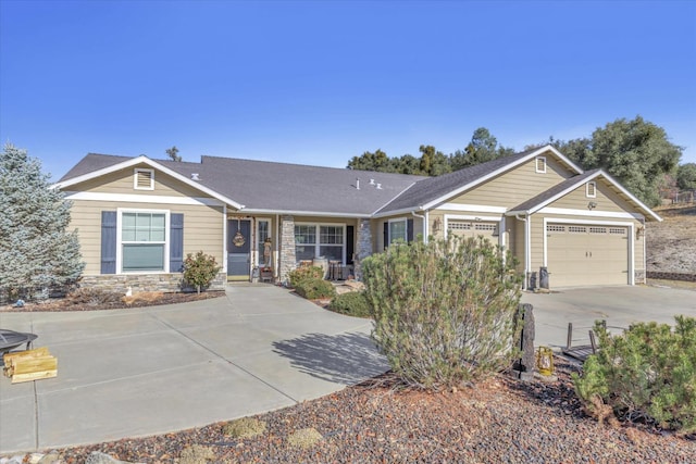 ranch-style house with covered porch, driveway, stone siding, and a garage