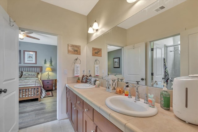 bathroom featuring double vanity, visible vents, a sink, and tile patterned flooring
