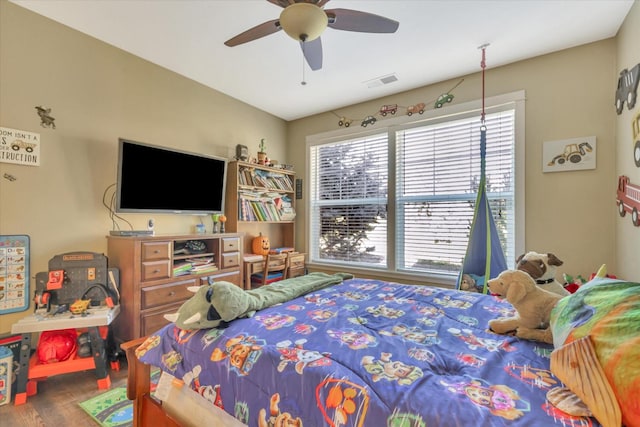 bedroom with visible vents, a ceiling fan, and wood finished floors
