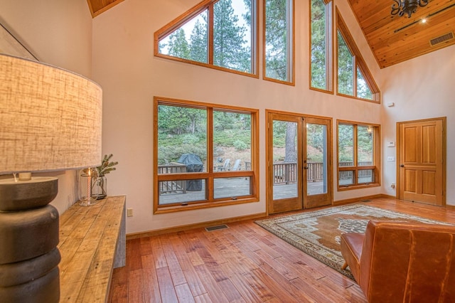 40596 Wild Iris Ln, Shaver Lake, CA 93664 - doorway to outside with visible vents, a healthy amount of sunlight, high vaulted ceiling, and french doors