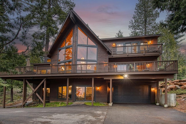 40596 Wild Iris Ln, Shaver Lake, CA 93664 - back of property with an attached garage, driveway, and a deck