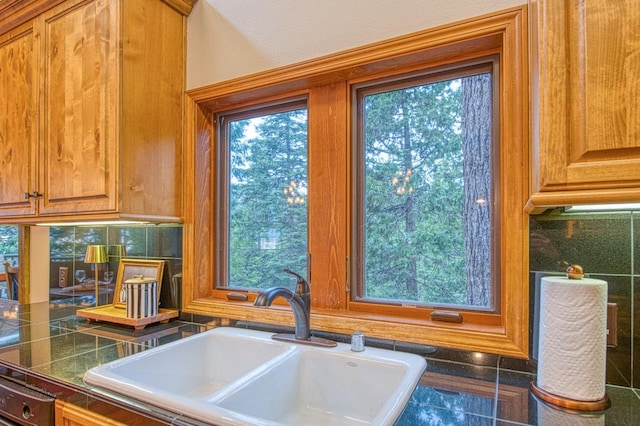 40596 Wild Iris Ln, Shaver Lake, CA 93664 - room details with brown cabinetry, decorative backsplash, and a sink