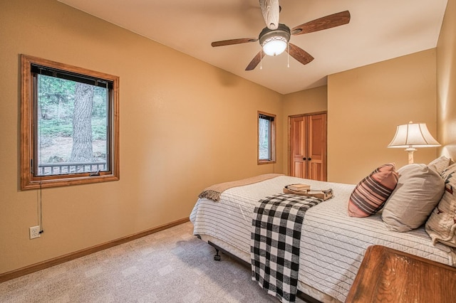 40596 Wild Iris Ln, Shaver Lake, CA 93664 - bedroom with baseboards, multiple windows, ceiling fan, and light colored carpet