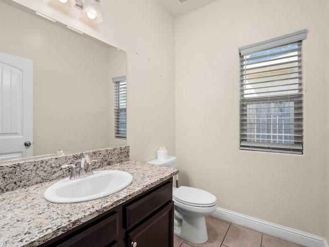 bathroom featuring toilet, baseboards, tile patterned flooring, and vanity