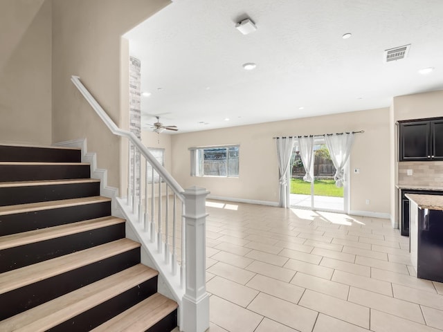 stairs with recessed lighting, ceiling fan, and baseboards