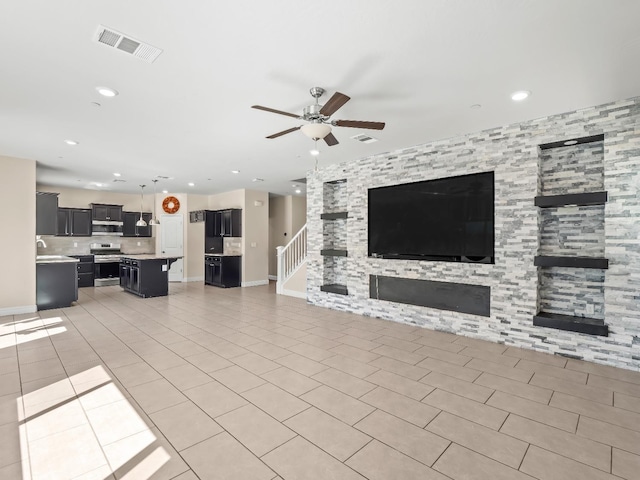 unfurnished living room with a ceiling fan, baseboards, recessed lighting, light tile patterned floors, and visible vents
