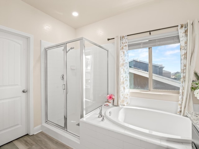 bathroom with a bath and a shower stall