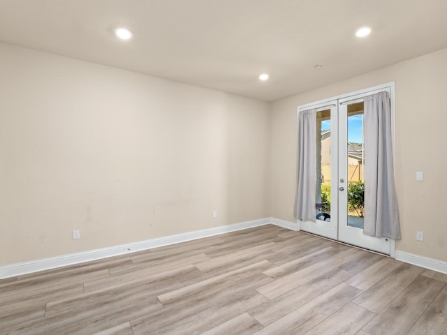 unfurnished room featuring light wood-type flooring, recessed lighting, baseboards, and french doors