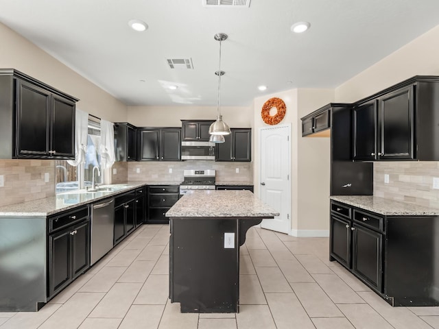 kitchen with backsplash, visible vents, a sink, dark cabinetry, and stainless steel appliances