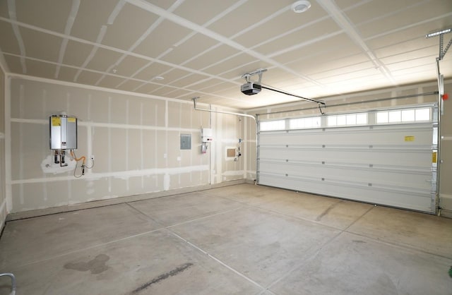 garage featuring tankless water heater and a garage door opener