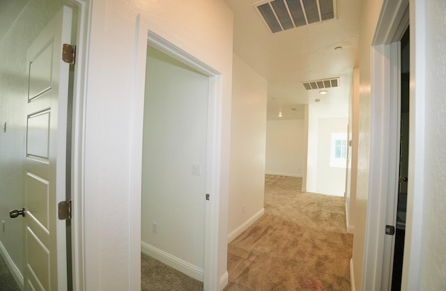 corridor with carpet flooring, baseboards, and visible vents