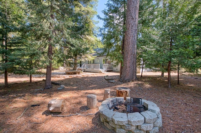 view of yard with a fire pit and a deck